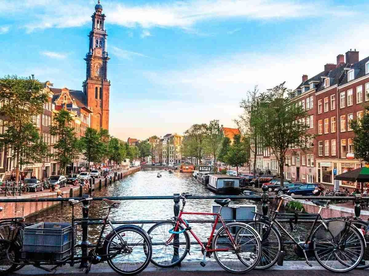 Amsterdam canals, bicycles and Westerkerk on a bright day