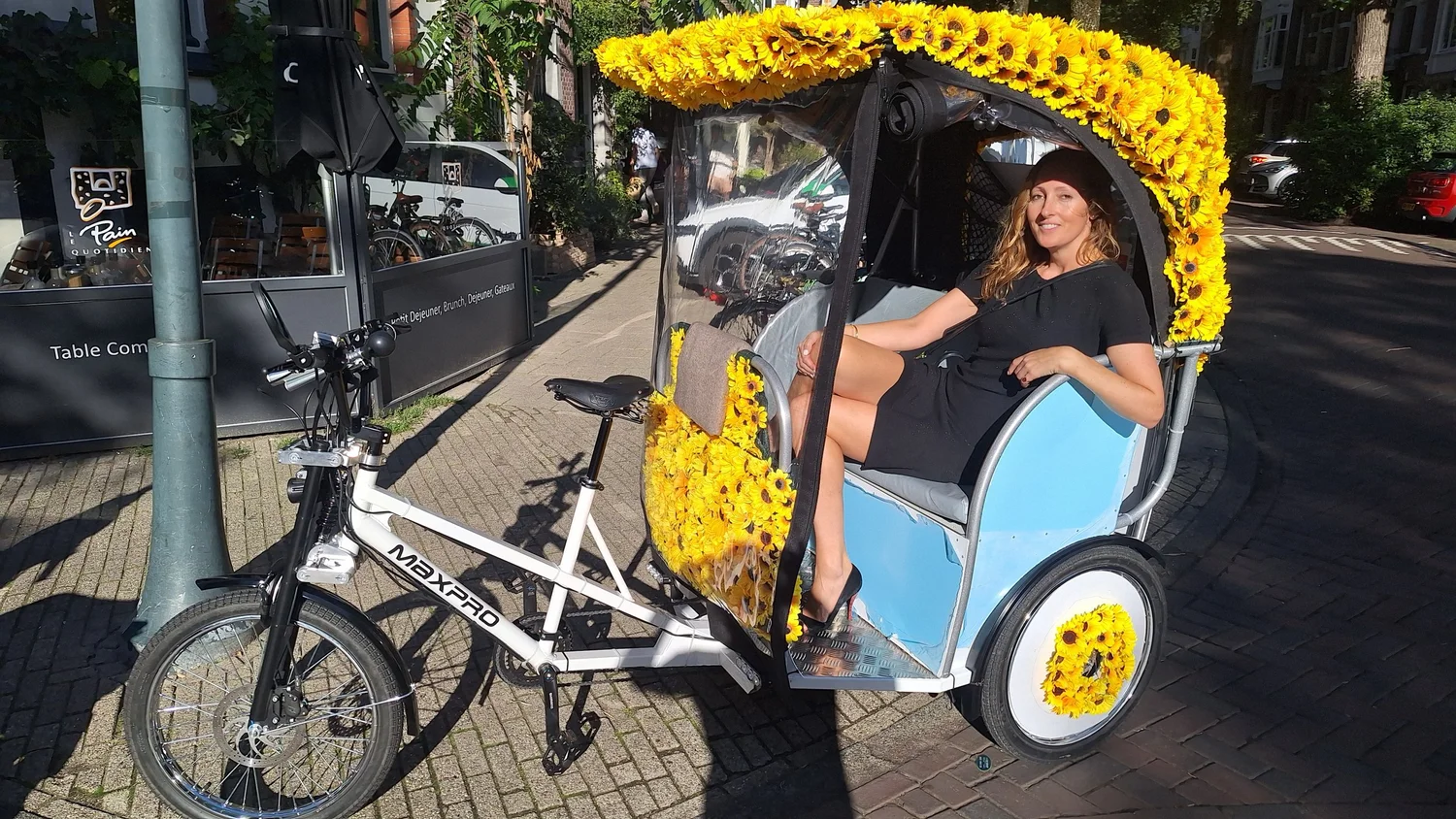 A passenger enjoying the original Amsterdam rickshaw