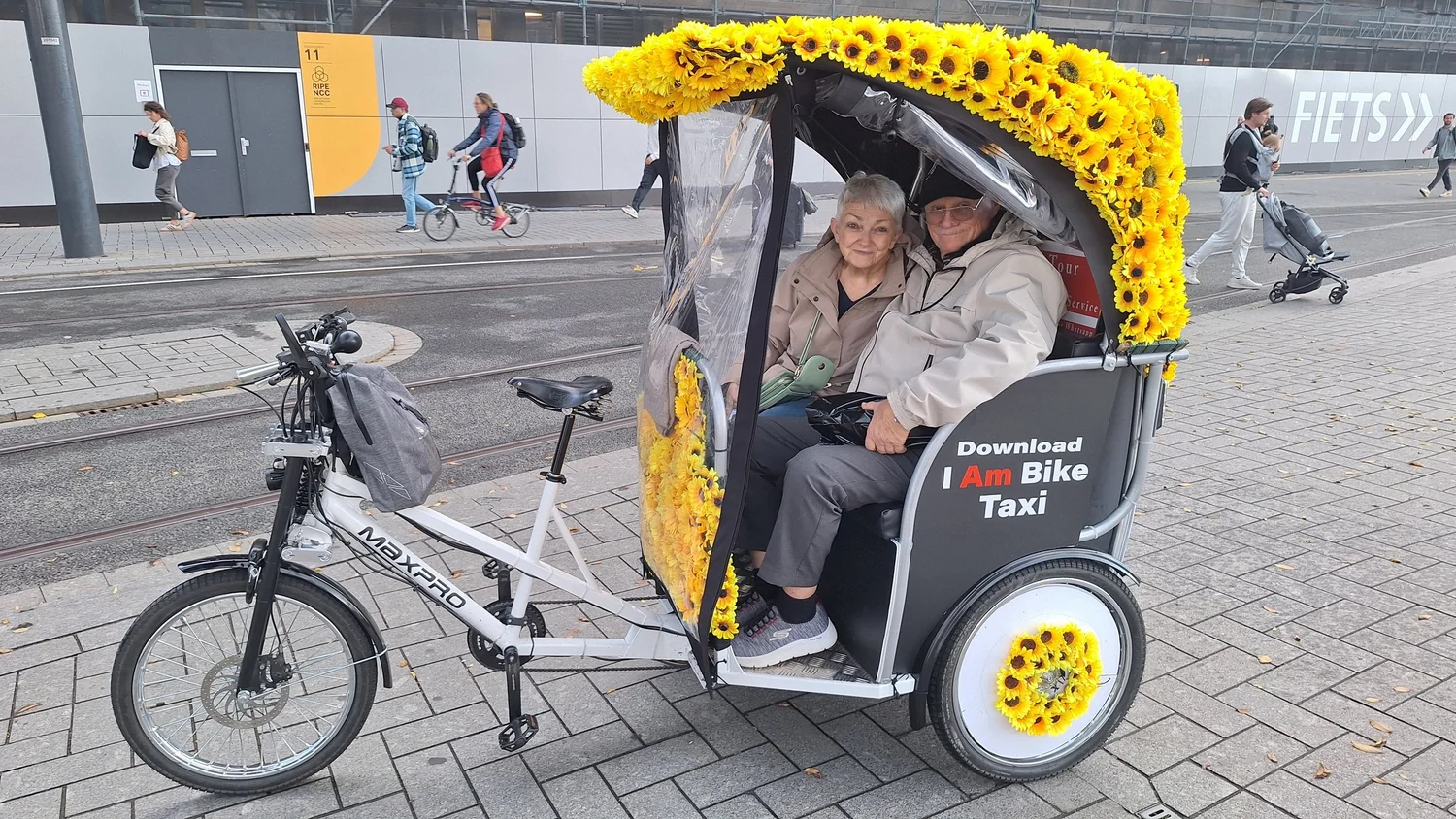 Guests seated comfortably in the Amsterdam rickshaw